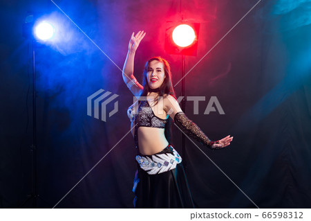 Spirituality dance. Beautiful sexy woman with luxury glossy eastern make-up dancing tribal fusion. Belly dance. Spirituality dance. Beautiful sexy woman with luxury glossy eastern make-up dancing tribal fusion. Belly dance. 66598312