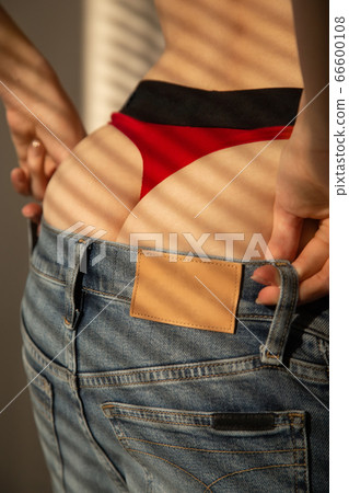 young woman undressing 66600108