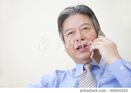 Businessman calling by mobile phone Businessman calling by mobile phone 66600283