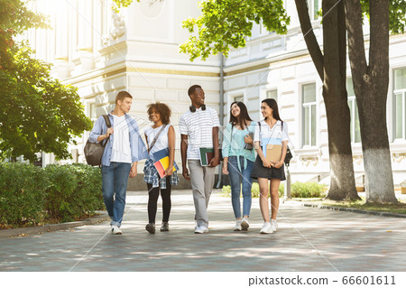 Campus Life. Group of international students walking outdoors after classes Campus Life. Group of international students walking outdoors after classes 66601611