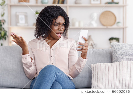 Angry Black Woman Shouting On Cellphone, Having Phone Quarrel At Home Angry Black Woman Shouting On Cellphone, Having Phone Quarrel At Home 66602086