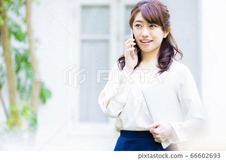Young woman making a phone call outdoors Young woman making a phone call outdoors 66602693