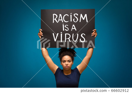 Black woman protesting with poster Racism is a Virus 66602912