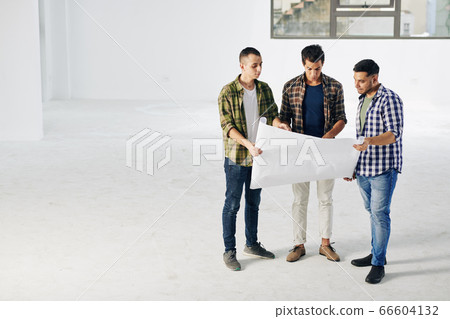 Engineers With Building Plan Paper Engineers With Building Plan Paper 66604132