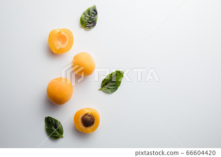 Close-up of ripe peaches on the table. Ripe peaches with leaves Close-up of ripe peaches on the table. Ripe peaches with leaves 66604420