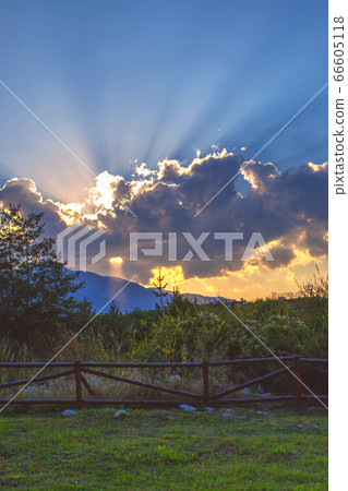 Powerful sun rays beaming through the clouds Powerful sun rays beaming through the clouds 66605118