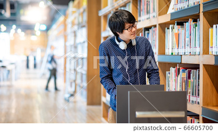 Asian man university student in college library Asian man university student in college library 66605700