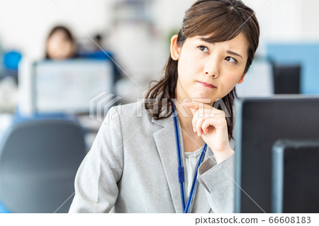 A female employee who operates a personal computer at the office A female employee who operates a personal computer at the office 66608183