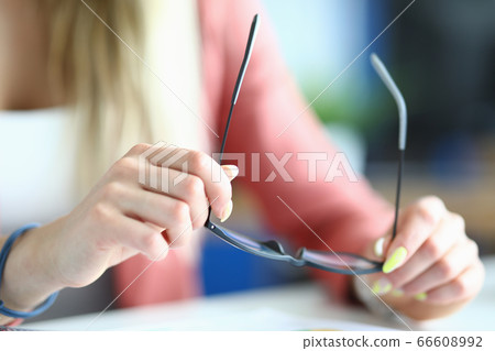Blonde employee sitting in office Blonde employee sitting in office 66608992
