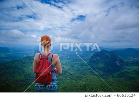 Happy hiker with her arms outstretched, freedom Happy hiker with her arms outstretched, freedom 66610124
