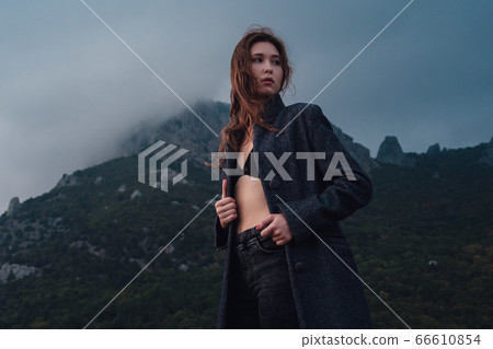 Asian woman in a gray coat enjoying the view in Asian woman in a gray coat enjoying the view in 66610854
