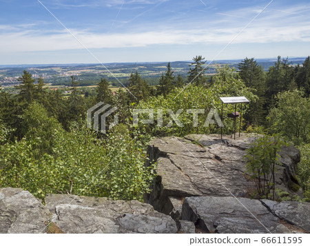 Viewpoint in Brdy mountain hills, with green trees, rocks town and blue sky, Czech Republic 66611595