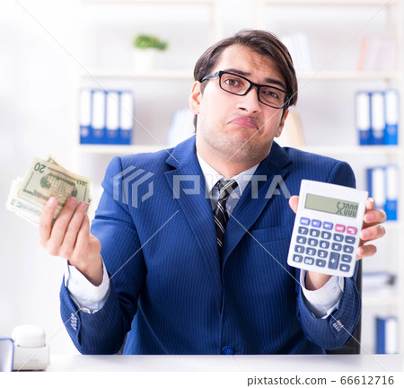 Accountant calculating dollars with calculator in office 66612716