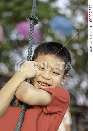 Asean boy at the nodes the rope and smiling happily. 66612733