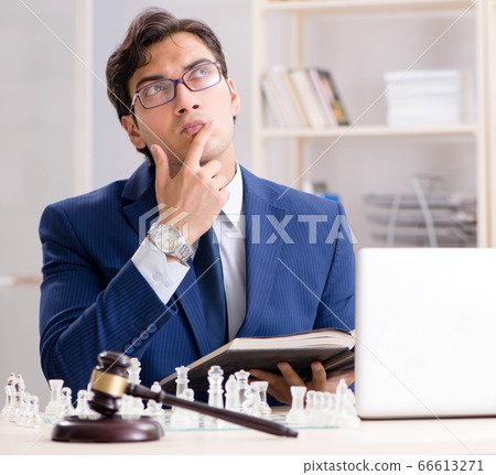 Young lawyer playing chess to train his court strategy and tacti 66613271