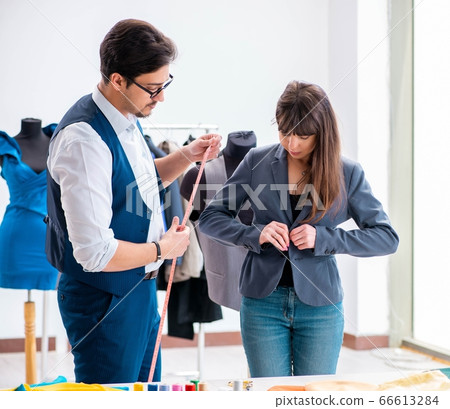 Professional tailor taking measurements for formal suit Professional tailor taking measurements for formal suit 66613284