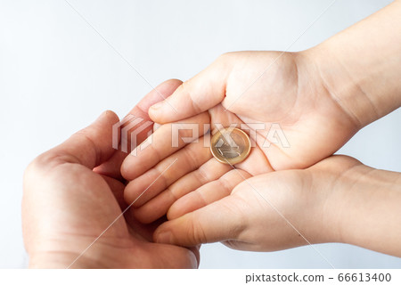 Close up of father and child hands holding euro money coins. Family, children, money, Investments, people concept Close up of father and child hands holding euro money coins. Family, children, money, Investments, people concept 66613400