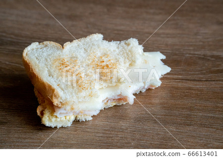 Half Eaten Sandwich thrown on the floor. Discarded Sandwich. Bread tossed to the floor. Thrown into the trash food. Concept. Half Eaten Sandwich thrown on the floor. Discarded Sandwich. Bread tossed to the floor. Thrown into the trash food. Concept. 66613401