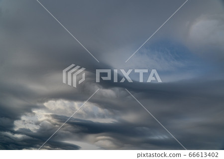 Dark ominous grey storm clouds. Dark ominous grey storm clouds. 66613402