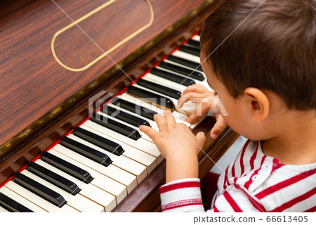 Litlle boy playing the piano Litlle boy playing the piano 66613405