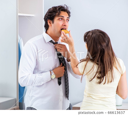 Woman sees her husband off to work 66613637