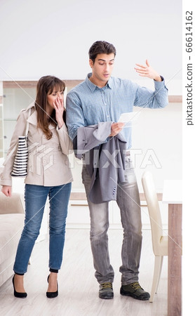 Young couple disappointed with price in furniture store 66614162