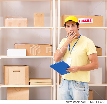 Handsome contractor working in box delivery relocation service Handsome contractor working in box delivery relocation service 66614372