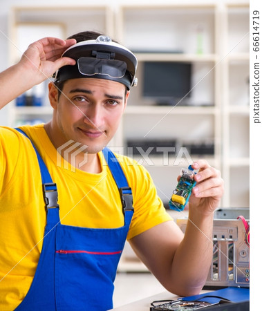 Computer repair technician repairing hardware 66614719