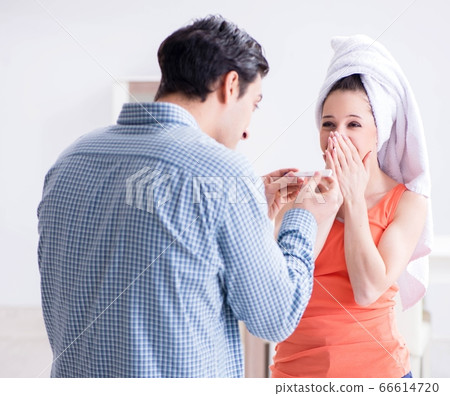 Wife and husband looking at pregnancy test Wife and husband looking at pregnancy test 66614720