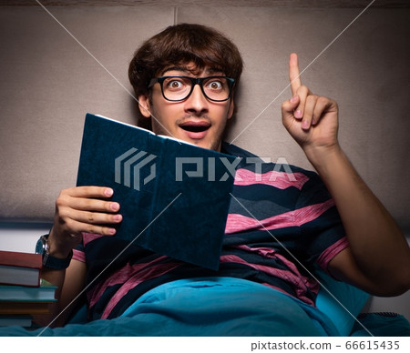 Young student preparing for exams at night at home Young student preparing for exams at night at home 66615435