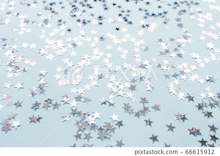 Silver foil confetti stars on blue background Silver foil confetti stars on blue background 66615912
