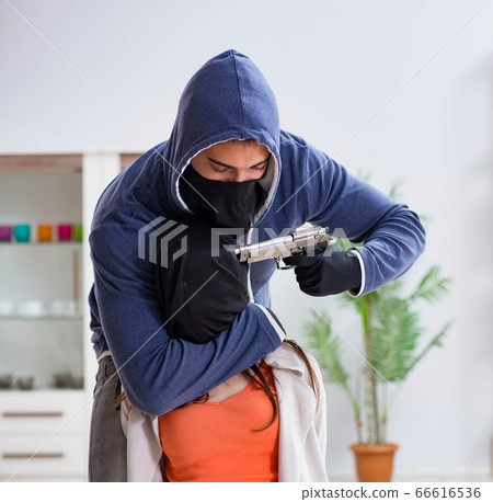 Armed man assaulting young woman at home 66616536