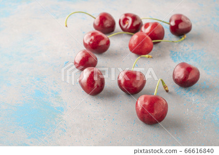 fresh ripe cherry fruits on gray background with fresh ripe cherry fruits on gray background with 66616840