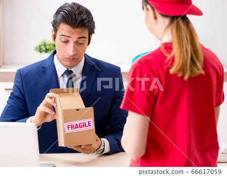 Courier delivering parcel to the office Courier delivering parcel to the office 66617059