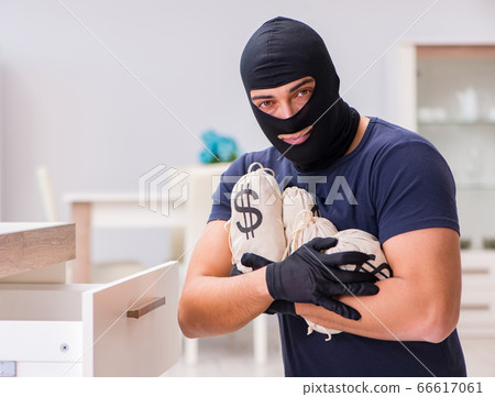 Robber wearing balaclava stealing valuable things 66617061