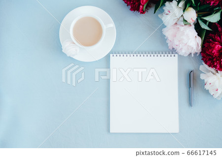 Notebook and coffee on blue background Notebook and coffee on blue background 66617145