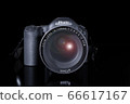 Front view of professional digital single lens reflex camera with a zoom lens and a strap on a black background with copy space. Realistic 3d render. Place for advertising text. Reflection at bottom 66617167