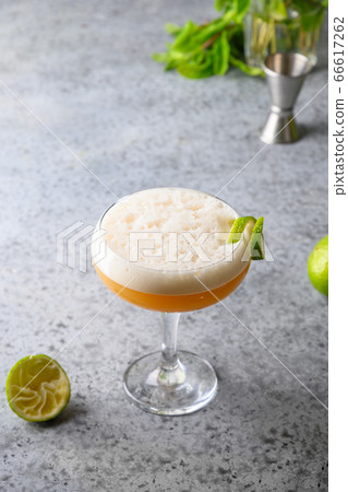 Pisco sour cocktail of whiskey, lime on grey. 66617262