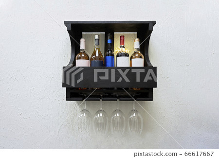 Set of bottles and glass of elite red wine on wooden shelf 66617667