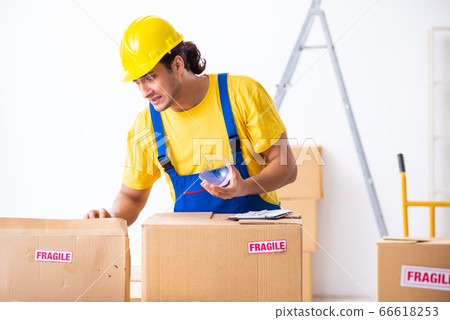 Young male professional mover doing home relocation Young male professional mover doing home relocation 66618253