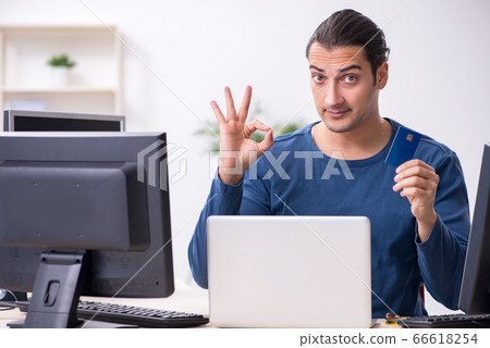 Young male it specialist working in the office 66618254