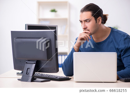 Young male it specialist working in the office Young male it specialist working in the office 66618255