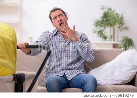 Young father looking after newborn baby at home Young father looking after newborn baby at home 66619279