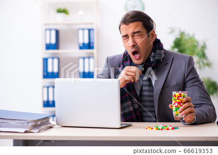 Young male employee suffering at workplace 66619353