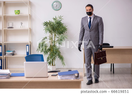Young male employee in the office during pandemic disease Young male employee in the office during pandemic disease 66619851
