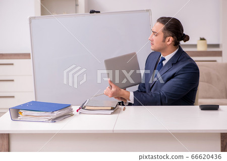 Young male employee working at home during pandemic disease Young male employee working at home during pandemic disease 66620436