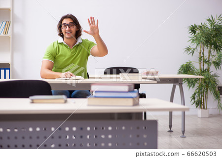 Young male student in the classroom 66620503
