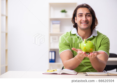 Young male student in the classroom Young male student in the classroom 66620504