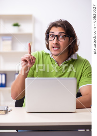 Young male student in the classroom 66620527