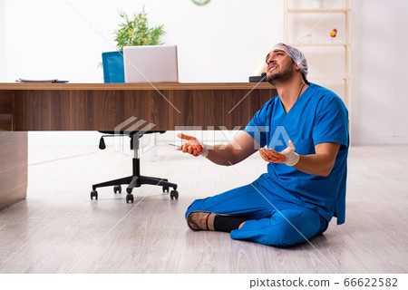 Young male doctor surgeon in fatal negligence concept 66622582